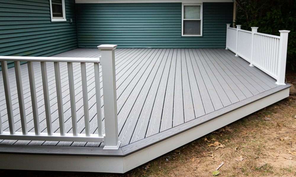 Eco-friendly deck in Annapolis, MD, featuring white railings and green siding for a fresh look.
