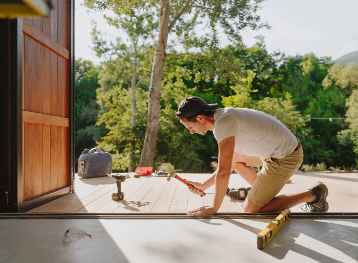 Man working on wooden deck - Deck Maintenance
