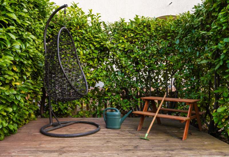 A wooden deck in Annapolis, MD, featuring a swing and a bench for relaxation.