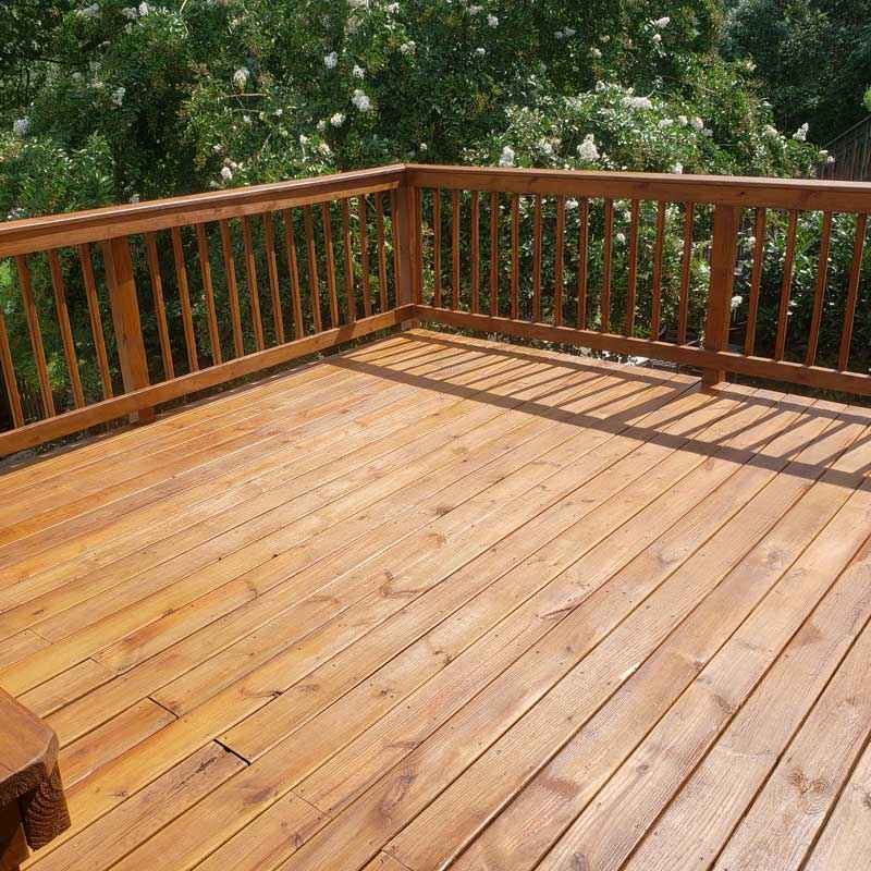 Restored wooden deck featuring a railing and bench, located in Glen Burnie, MD.
