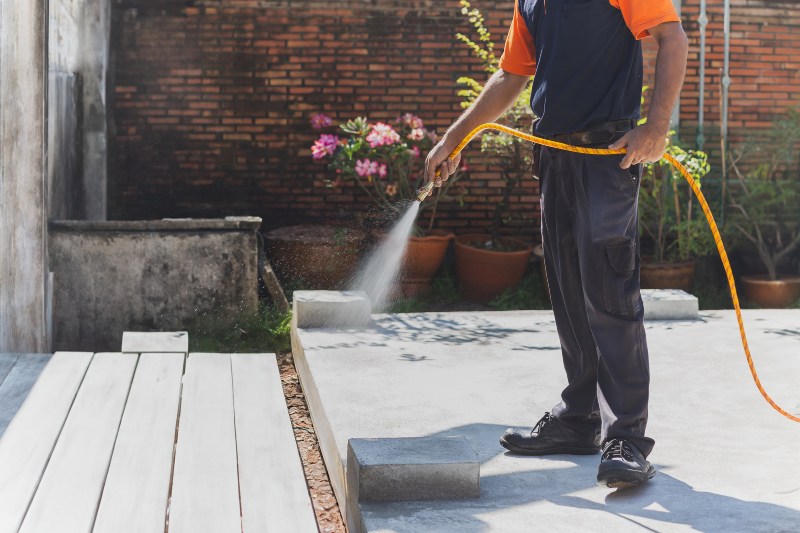 A Professional Sprays Termite Treatment on a Deck to Protect It from Damage in Annapolis, MD