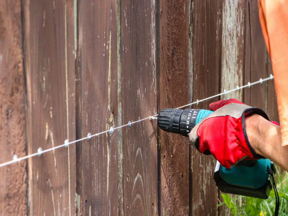Emergency fence repair in Annapolis, MD, with damaged fence being restored
