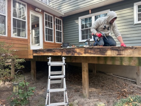 Newly constructed backyard deck installation with stairs and modern railing system