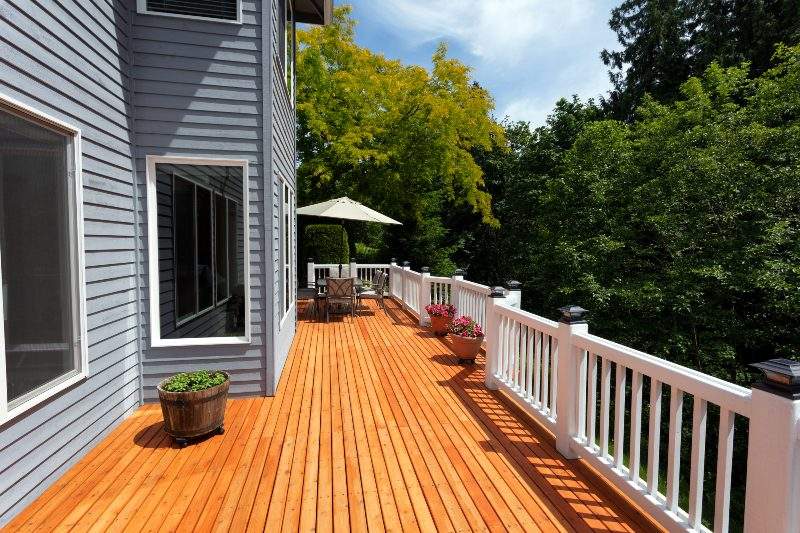 A Freshly Restored Wood Deck with White Railings After a Deck Safety Evaluation in Annapolis, MD