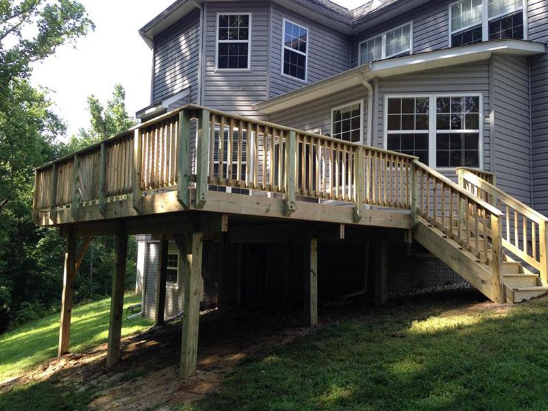 An Elevated Wood Deck Remodeled with New Railings and a Backyard Staircase in Annapolis, MD
