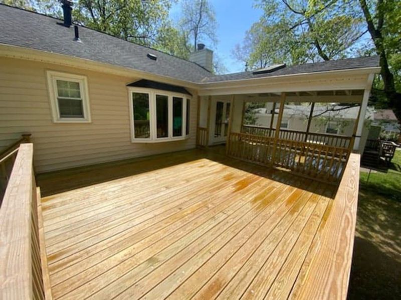 A Remodeled Backyard Deck with Fresh Wood Decking and a Covered Patio Area in Annapolis, MD